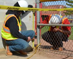 Highway construction students at KCC working on a chain-link fence